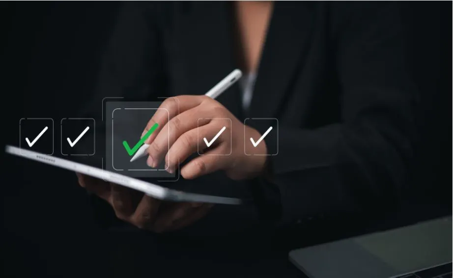 Business professional reviewing PoSH compliance checklist on tablet