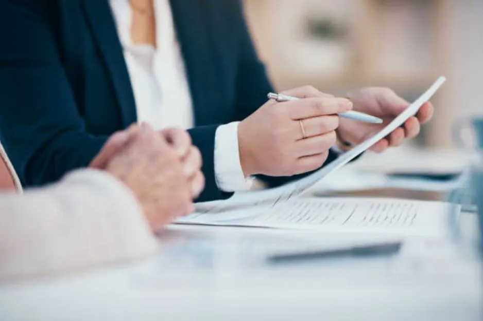Business professionals reviewing a PoSH policy document